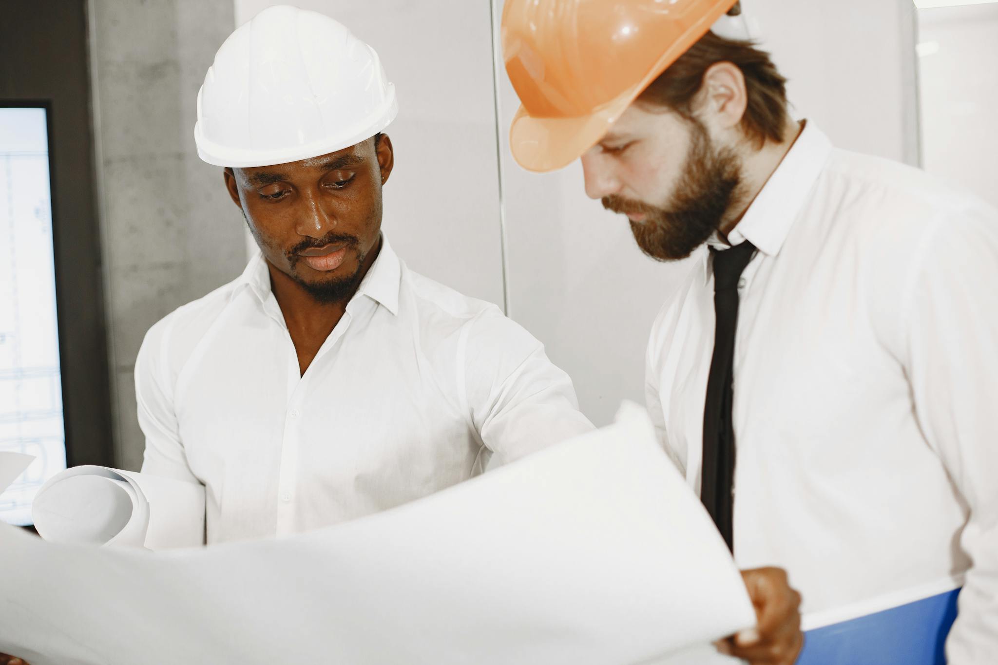 Two engineers in hard hats working